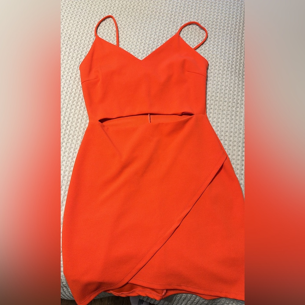 Orange mini dress with mid drift cut out.